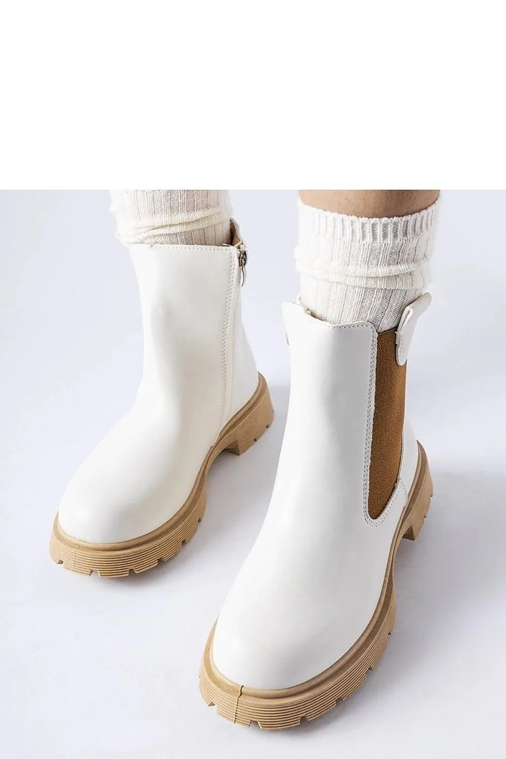 White ankle boots with a beige sole